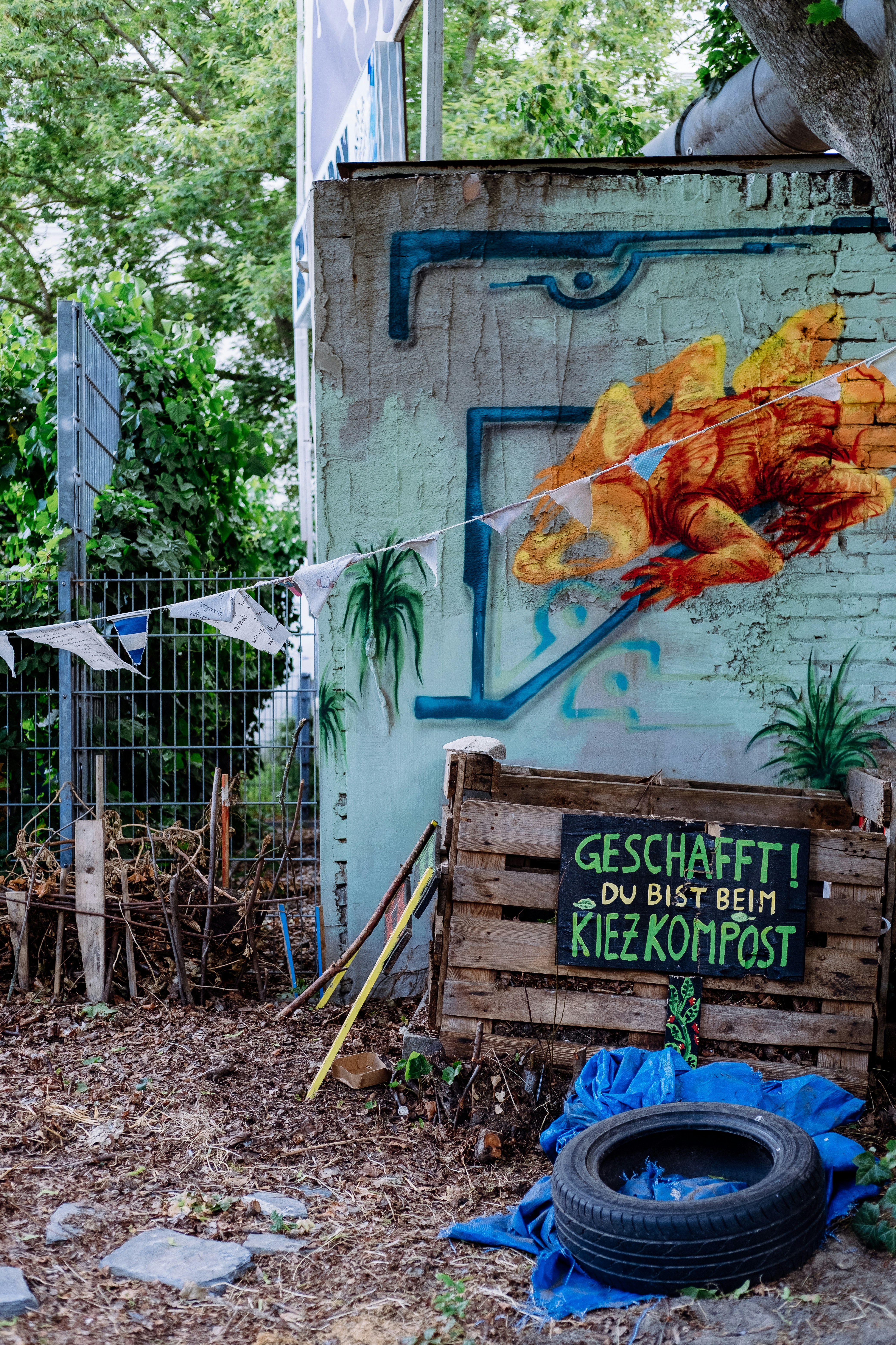 A family putting fruit scraps into a compost bin in the garden