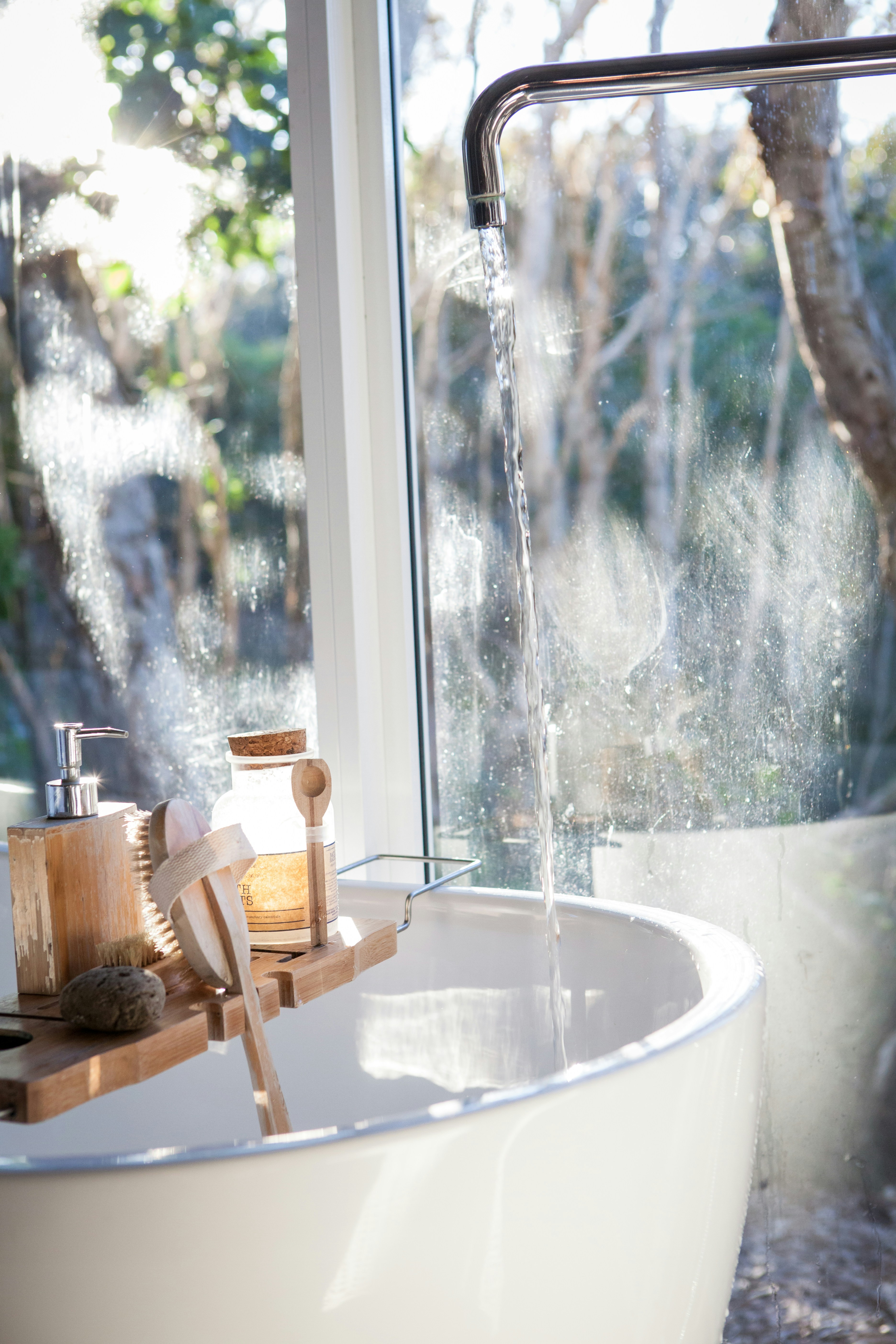 A bamboo toothbrush, shampoo bar, and safety razor on a bathroom shelf