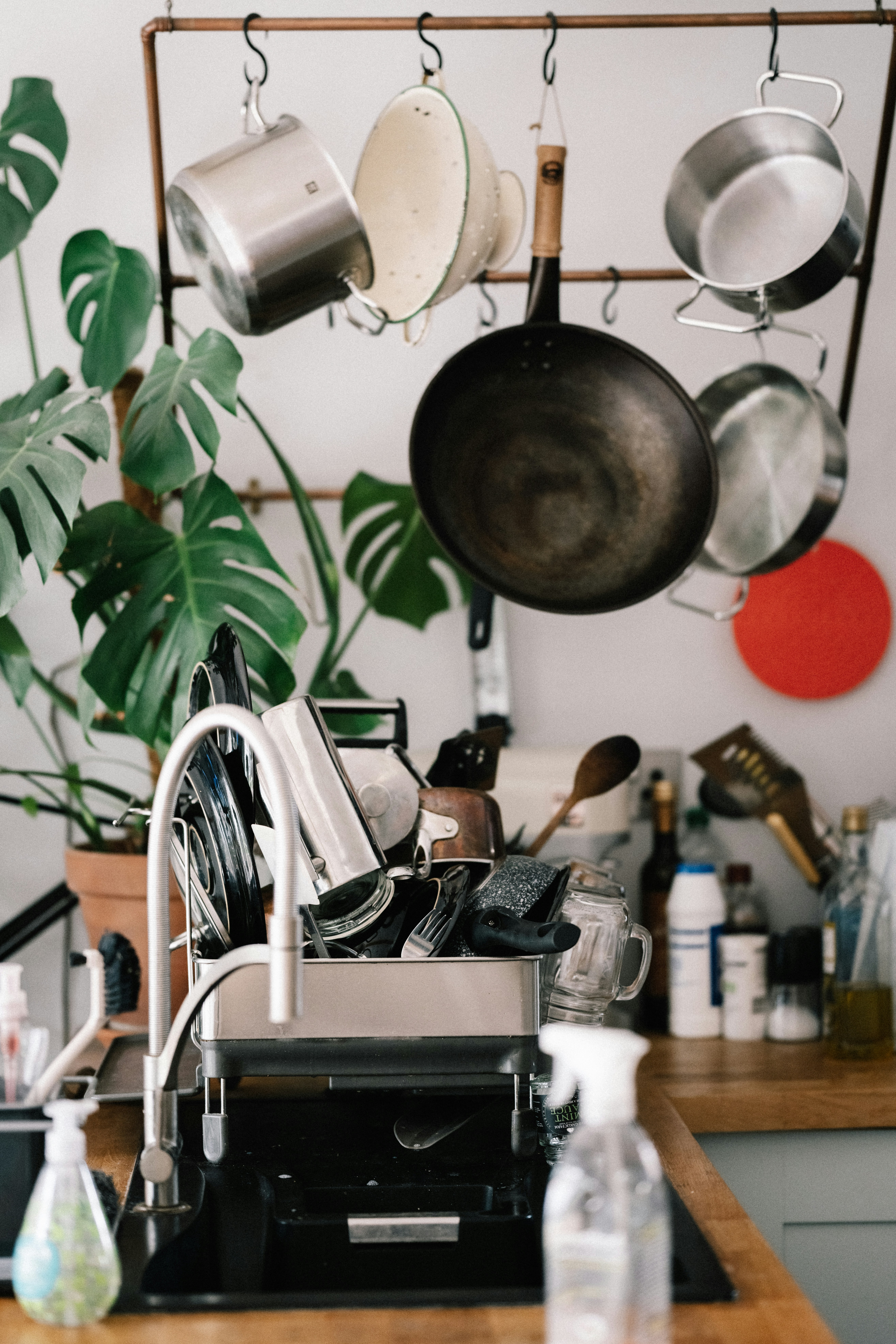A kitchen counter with glass jars, reusable bags, and fresh produce