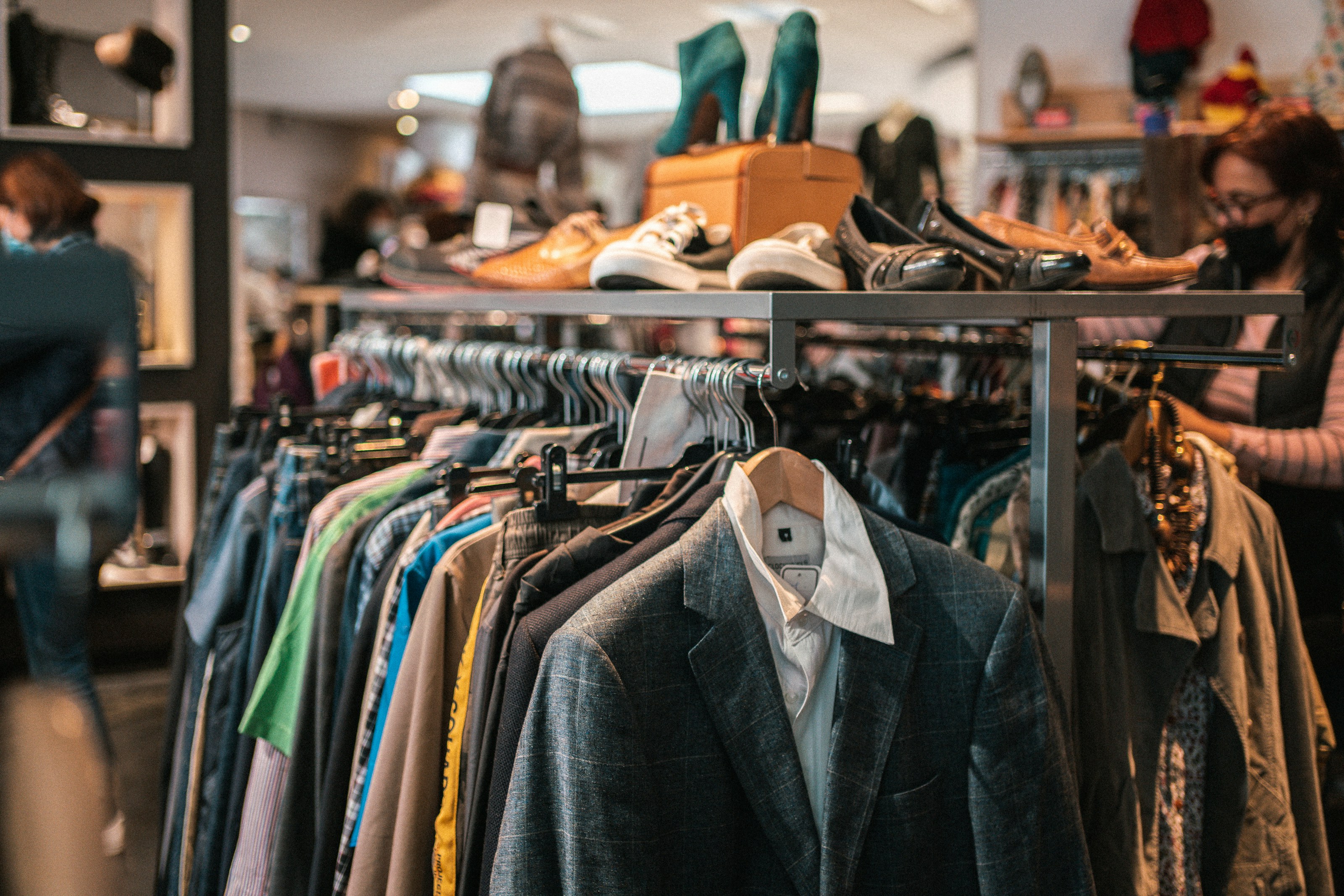 A rack of neatly organised secondhand children's clothing