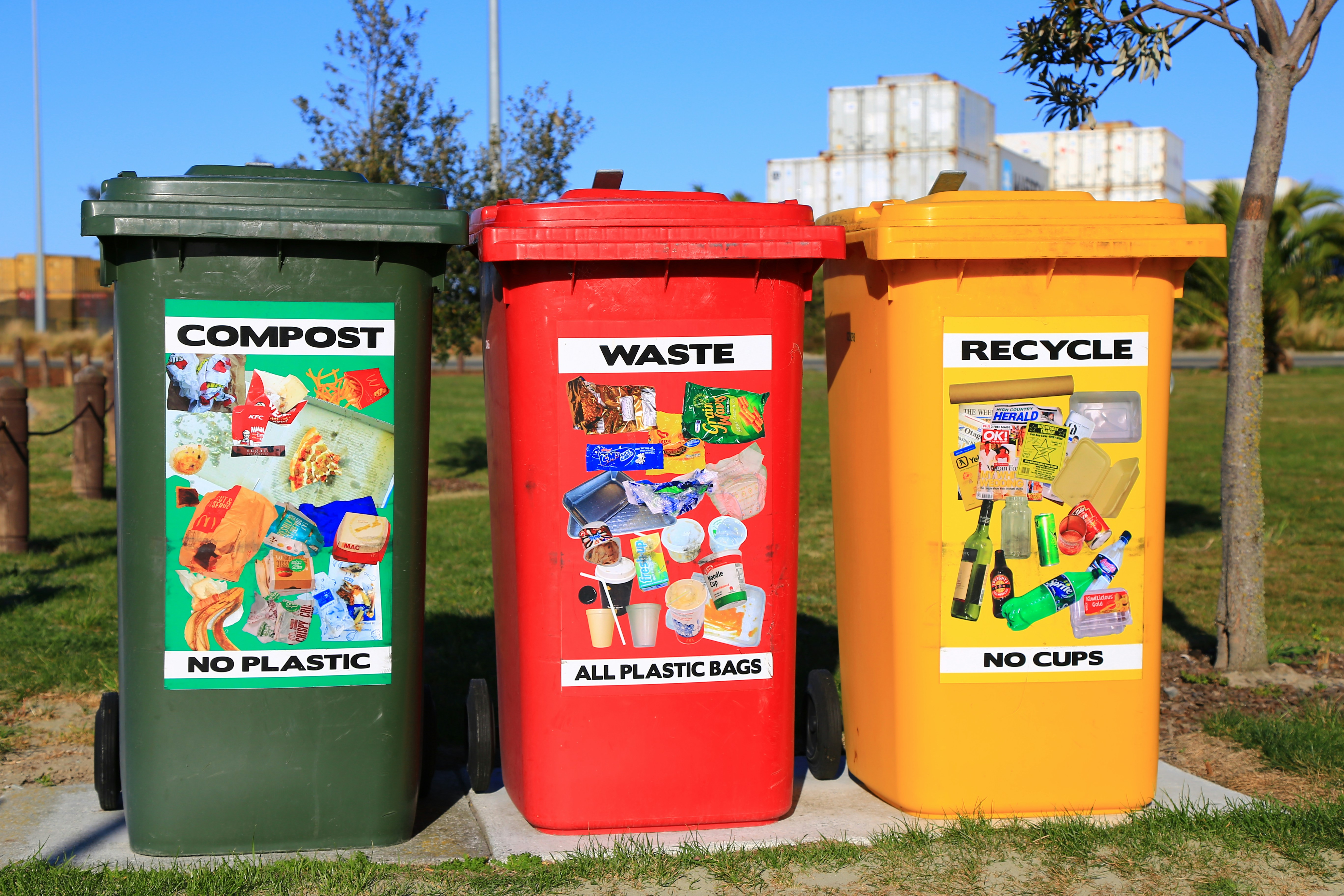 A family sorting items into recycling bins at home